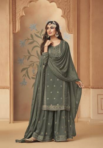 This Festive And Wedding Season, Be The Most Beautiful Diva Wearing This Designer Straight Suit In Dusty Fine Color. Its Embroidered With Hand Work Top Is Fabricated on Georgette Paired With Georgette Work Bottom And Chiffon Swarovski  Dupatta. Buy Now. 

