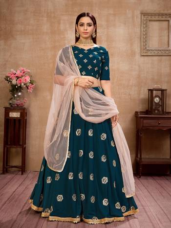 Here Is Lovely and Elegant Looking Designer Lehenga Choli In Teal Colored Blouse Paired With Teal Colored Lehenga And Peach Dupatta. Its Blouse Is Georgette Based Paired With Georgette Fabricated Lehenga And Net Fabricated Dupatta. Buy Now. 