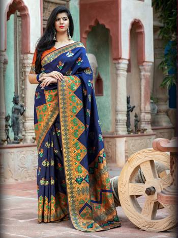 Adorn The Pretty Angelic Look Wearing This Heavy Weaving Designer Saree In Nevy Blue Color Paired With Contrasting Orange Colored Blouse. This Saree Is Fabricated On Patola Silk Paired With Blouse. Its Pretty Color Pallete Will Give An Attractive Look To Your Personality. 