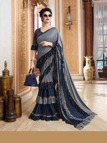 Add This Trendy Designer Ruffle Saree To Your Wardrobe In English Color. This Pretty Saree Is Fabricated On Imported Paired With Blouse. It Is Beautified With Pretty Ruffles And Hand Embroidered Patch Work.

