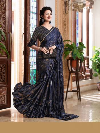 Add This Trendy Designer Ruffle Saree To Your Wardrobe In English Color. This Pretty Saree Is Fabricated On Imported Paired With Blouse. It Is Beautified With Pretty Ruffles And Hand Embroidered Patch Work.

