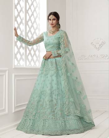 Get Ready For The Upcoming Wedding and Festive Season Wearing This Heavy Designer Lehenga Choli In Light Color. Its Blouse And Lehenga Are Fabricated On Net Beautified With Heavy Attractive Embroidery. 

