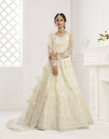 Get Ready For The Upcoming Wedding and Festive Season Wearing This Heavy Designer Lehenga Choli In Light Color. Its Blouse And Lehenga Are Fabricated On Net Beautified With Heavy Attractive Embroidery. 

