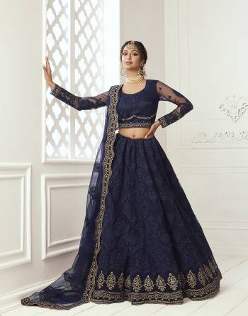 Get Ready For The Upcoming Wedding and Festive Season Wearing This Heavy Designer Lehenga Choli In Dark Color. Its Blouse And Lehenga Are Fabricated On Net Beautified With Heavy Attractive Embroidery. 

