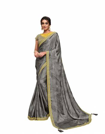 Adorn The Pretty Angelic Look Wearing This Heavy Designer Saree In Fine Paired With Contrasting Colored Blouse. This Saree Is Fabricated On Satin Silk Paired With Raw Silk,Net Fabricated Blouse. Its Pretty Color Pallete Will Give An Attractive Look To Your Personality. 