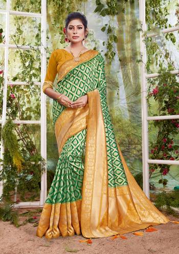 Flaunt Your Rich And Elegant Taste In This Green Colored Saree Paired With Golden Colored Blouse. This Saree And Blouse Are Fabricated On Silk Beautified With Weave. Buy This Saree Now.