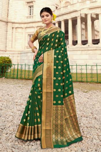 Here Is A Pretty Designer Saree In Green Color Paired With Golden Colored Blouse. This Saree And Blouse Are Fabricated On Silk Beautified With Weaved Motifs And Broad Border.