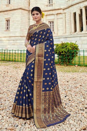 Here Is A Pretty Designer Saree In Nevy Blue Color Paired With Golden Colored Blouse. This Saree And Blouse Are Fabricated On Silk Beautified With Weaved Motifs And Broad Border.