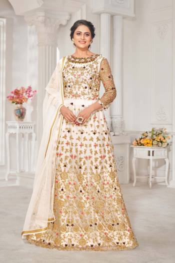 Look Pretty This Designer Floor Length Suit In Lovely White Color.?Its Pretty Embroidred Top Is Net Based Paired With Silk Bottom And Net Fabricated Embroidered Dupatta Which Gives An Attractive To The Suit.