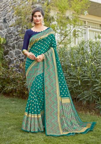 Grab This Pretty Elegant Looking Designer Saree In Green Color Paired With Contrasting Blue Colored Blouse. This Saree And Blouse Are Silk Based Beautified With Heavy Wevon Border Pallu With Sirki Work. Buy Now.