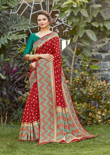 Grab This Pretty Elegant Looking Designer Saree In Red Color Paired With Contrasting Green Colored Blouse. This Saree And Blouse Are Silk Based Beautified With Heavy Wevon Border Pallu With Sirki Work. Buy Now.