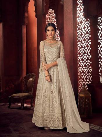 Look Pretty In This Beautiful Designer Floor Length Dress In Chiku Color Paired With Dupatta. This Semi-Stitched Dress Are Fabricated On Net Beautified With Pretty Embroidery. Buy Now