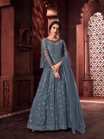 Look Pretty In This Beautiful Designer Floor Length Dress In Grey Color Paired With Dupatta. This Semi-Stitched Dress Are Fabricated On Net Beautified With Pretty Embroidery. Buy Now