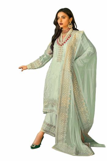 Grab This Pretty Heavy Embroidered Pakistani Designer Salwar Kameez In Green Color. Its Embroidered Top Is Faux Georgette Based Paired With Santoon Bottom and Nazneen Fabricated Embroidered Dupatta.