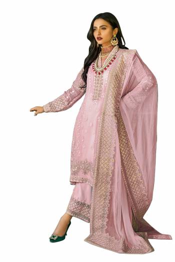 Grab This Pretty Heavy Embroidered Pakistani Designer Salwar Kameez In Pink Color. Its Embroidered Top Is Faux Georgette Based Paired With Santoon Bottom and Nazneen Fabricated Embroidered Dupatta.