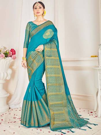 Look Attractive Wearing This Teal Colored Saree Paired With Blouse.  This Heavy Wevon Jacquard Designer Saree Is Banarasi Silk Based Which Gives A Rich Look To Your Personality. Buy This Pretty Saree Now.