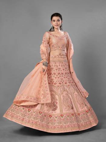 This Beautiful Heavy Designer Lehenga Choli Is Peach Color. This Attractive Embroidered Lehenga Choli Is Fabricated On Satin Paired With Soft Net Fabricated Dupatta. It Is Light In Weight And Easy To Carry All Day Long.