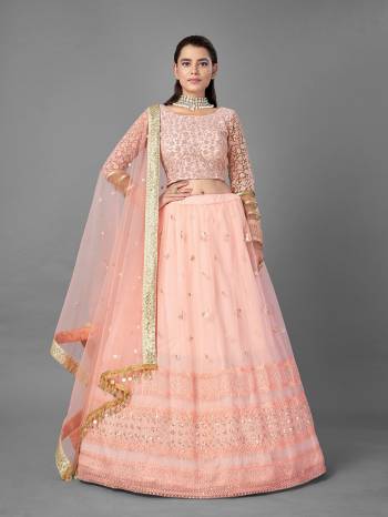 Evergreen Combination Is Here With This Heavy Designer Lehenga Choli In Peach Color. Its Blouse And Lehenga Are Fabricated On Soft Net Paired With Soft Net Fabricated Dupatta. Buy Now