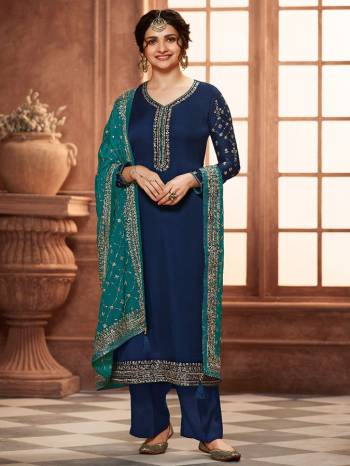 Grab This Very Beautiful Designer Straight Suit In Blue Color Paired With Pretty Embroidered Contrasted Colored Dupatta. Its Top Is Fabricated On Satin Georgette Paired With Santoon Bottom and Chinon Fabricated Dupatta. Buy This Designer Embroidered Suit Now