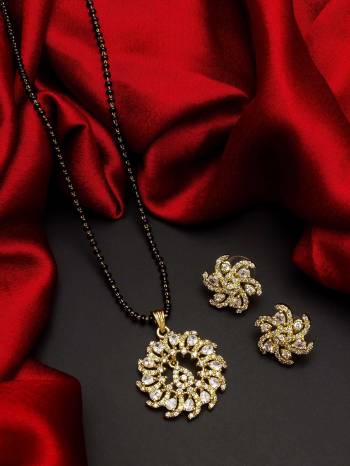 Give An Enhanced Look To Your Personality By Pairing Up This Beautiful Mangal Sutra Set With Your Ethnic Attire. This Pretty Set Is In Gold Color Beautified With American Diamond. Buy Now.