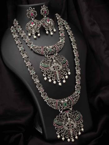 Give An Enhanced Look To Your Personality By Pairing Up This Beautiful Necklace Set With Your Ethnic Attire. This Pretty Set Is In Silver Color Beautified With Temple. Buy Now.