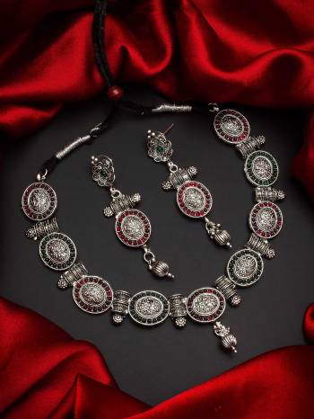 Give An Enhanced Look To Your Personality By Pairing Up This Beautiful Necklace Set With Your Ethnic Attire. This Pretty Set Is In Silver Color Beautified With Temple. Buy Now.