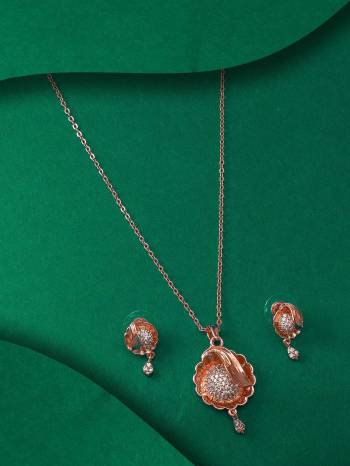 Give An Enhanced Look To Your Personality By Pairing Up This Beautiful Pendent Set With Your Ethnic Attire. This Pretty Set Is In Rose Gold Color Beautified With American Diamond Work. Buy Now.