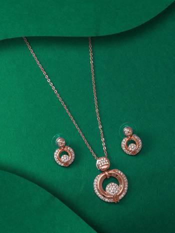 Give An Enhanced Look To Your Personality By Pairing Up This Beautiful Pendent Set With Your Ethnic Attire. This Pretty Set Is In Rose Gold Color Beautified With American Diamond Work. Buy Now.