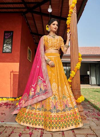 Look Pretty In This Designer Silk Based Lehenga Choli In Yellow Color Paired With Contrasting Pink Colored Dupatta. It Is Fabricated On Banarasi Jacquard Silk Beautified With Weave All Over. Buy This Pretty Piece Now.? 