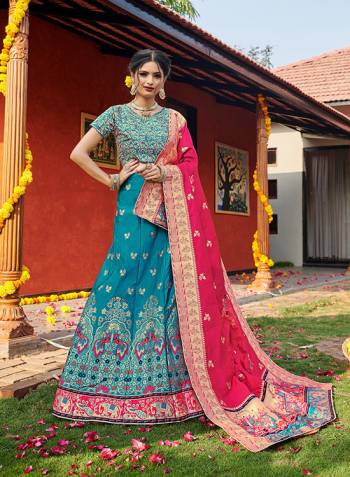 Look Pretty In This Designer Silk Based Lehenga Choli In Firozi Color Paired With Contrasting Pink Colored Dupatta. It Is Fabricated On Banarasi Jacquard Silk Beautified With Weave All Over. Buy This Pretty Piece Now.? 