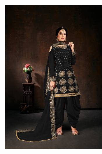 Here Is An Attractive Looking Mirror Embroidered Heavy Designer Suit In Black Color Paired With Dupatta. Its Top Is Fabricated On Faux Georgette Paired With Santoon Bottom And Net Fabricated Dupatta. Also, Its Dupatta Is Beautified With Embroidered Lace Border.