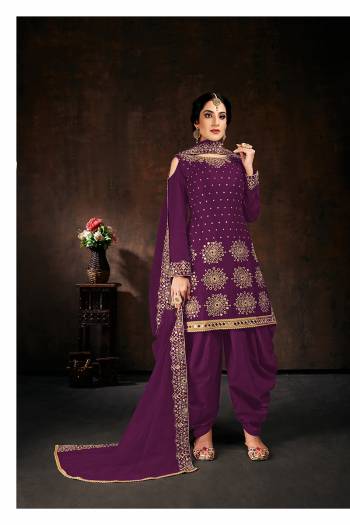 Here Is An Attractive Looking Mirror Embroidered Heavy Designer Suit In Purple Color Paired With Dupatta. Its Top Is Fabricated On Faux Georgette Paired With Santoon Bottom And Net Fabricated Dupatta. Also, Its Dupatta Is Beautified With Embroidered Lace Border.