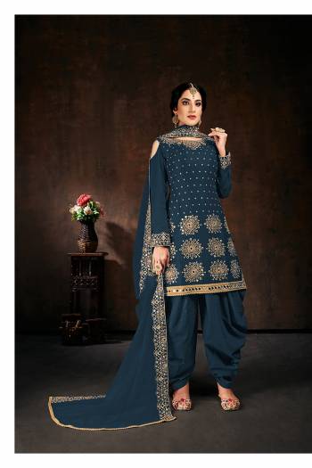 Here Is An Attractive Looking Mirror Embroidered Heavy Designer Suit In Aqua Blue Color Paired With Dupatta. Its Top Is Fabricated On Faux Georgette Paired With Santoon Bottom And Net Fabricated Dupatta. Also, Its Dupatta Is Beautified With Embroidered Lace Border.