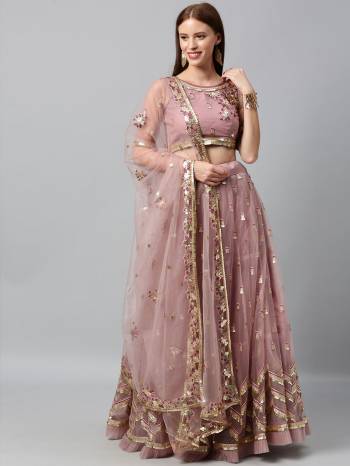 Evergreen Combination Is Here With This Heavy Designer Lehenga Choli In Light Color. Its Blouse And Lehenga Are Fabricated On Net Paired With Net Fabricated Dupatta. Buy Now