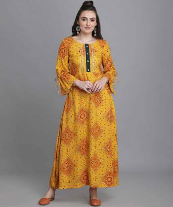 Add This Pretty Readymade Long Kurti To Your Wardrobe In Musterd Color. This Kurti Is Fabricated On Rayon Beautified With Bandhni Foil Print With Key Hole Neck.