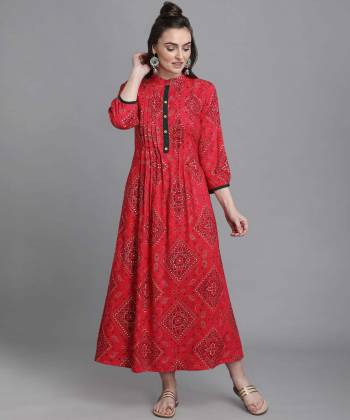 Add This Pretty Readymade Long Kurti To Your Wardrobe In Pink Color. This Kurti Is Fabricated On Rayon Beautified With Bandhni Foil Print With Key Hole Neck.