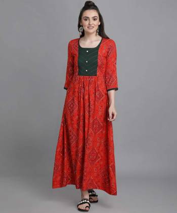 Add This Pretty Readymade Long Kurti To Your Wardrobe In Red Color. This Kurti Is Fabricated On Rayon Beautified With Bandhni Foil Print With Key Hole Neck.