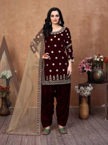 Get Ready For The Upcoming Festive And Wedding Season With This Designer Patiala Suit In Pine Brown Color Paired With Beige Colored Dupatta. Its Embroidered Top Is Fabricated On Velvet Paired With Santoon Bottom And Net Fabricated Gota Patti Border Dupatta. It Is Light Weight And Easy To Carry Throughtout The Gala. Buy this Suit Now.