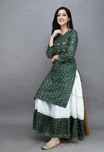 Grab This Designer Readymade Long Kurti With Skrit In Fine Color Fabricated On Rayon. It Is Beautified With Bandhej Block Prints And You Can Pair This Up With Tui Lace For A Festive Look. Buy Now.