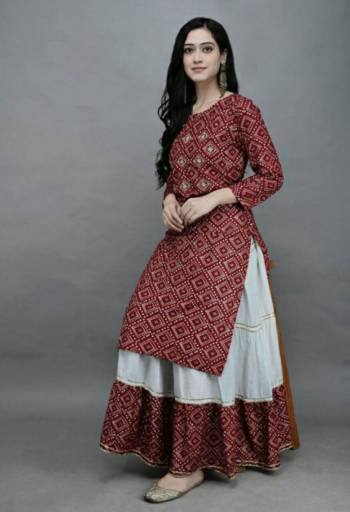 Grab This Designer Readymade Long Kurti With Skrit In Fine Color Fabricated On Rayon. It Is Beautified With Bandhej Block Prints And You Can Pair This Up With Tui Lace For A Festive Look. Buy Now.