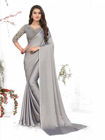 Adorn The Pretty Angelic Look Wearing This Heavy Wevon Designer Saree In Fancy Color Paired With Contrasting Grey Colored Blouse. This Saree Is Fabricated On Chiffon Paired With Micro Fabricated Blouse. Its Pretty Color Pallete Will Give An Attractive Look To Your Personality. 