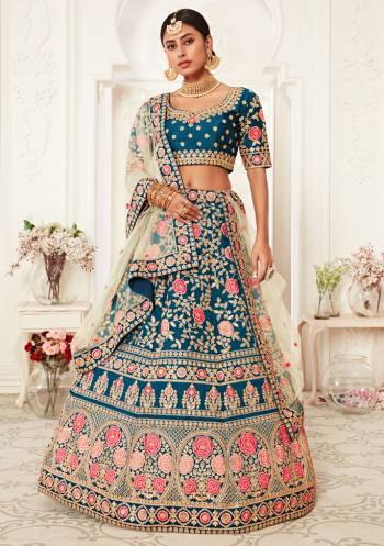 Garb This Heavy Designer Lehenga Choli In All Over Color. This Heavy Embroidered Lehenga Choli Is Slub Silk Based Paired With Soft Net Fabricated Dupatta, It Is Beautified With Lovely Detailed Heavy Embroidery Giving An Attractive Look.