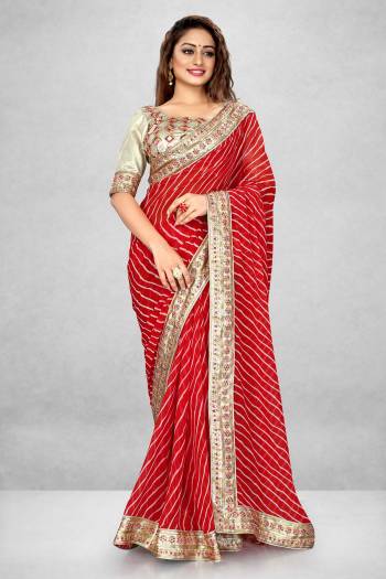 This Pretty Elegant Looking Designer Bandhani Saree In Red Color Paired With Beige Color Blouse. This Saree  Are Georgette And Blouse Are Banglori Satin Based With Printed And Heavy Work Lace And Work Blouse Beautified Saree. Buy Now.