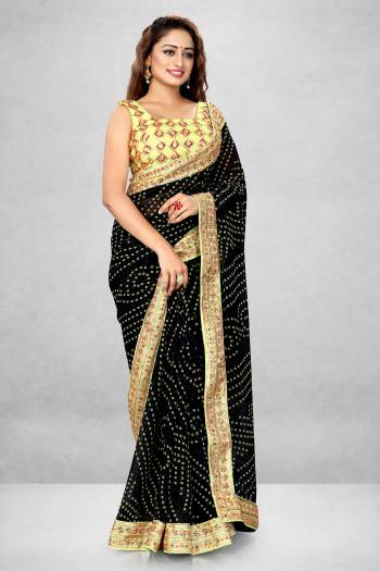 This Pretty Elegant Looking Designer Bandhani Saree In Black Color Paired With Yellow Color Blouse. This Saree  Are Georgette And Blouse Are Banglori Satin Based With Printed And Heavy Work Lace And Work Blouse Beautified Saree. Buy Now.