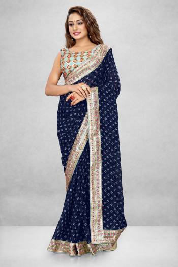 This Pretty Elegant Looking Designer Bandhani Saree In Blue Color Paired With Blue Color Blouse. This Saree  Are Georgette And Blouse Are Banglori Satin Based With Printed And Heavy Work Lace And Work Blouse Beautified Saree. Buy Now.