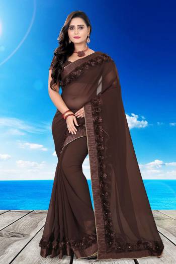 Celebrate This Festive Season And Party Wear In This Very Pretty Brown Colored Designer Saree Paired With Blouse. This Saree Are Georgette and Blouse Are Banglori Silk Based Beautified With Detailed Floral,Ribbon Work. 