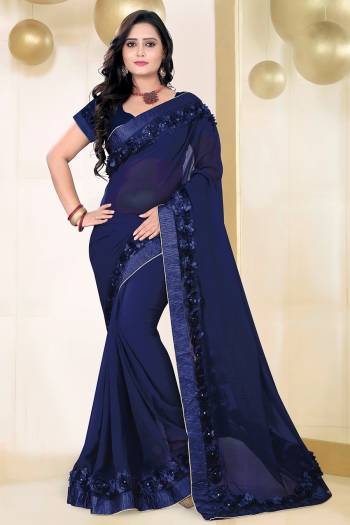 Celebrate This Festive Season And Party Wear In This Very Pretty Nevy Blue Colored Designer Saree Paired With Blouse. This Saree Are Georgette and Blouse Are Banglori Silk Based Beautified With Detailed Floral,Ribbon Work. 