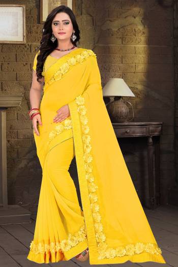 Celebrate This Festive Season And Party Wear In This Very Pretty Yellow Colored Designer Saree Paired With Blouse. This Saree Are Georgette and Blouse Are Banglori Silk Based Beautified With Detailed Floral,Ribbon Work. 