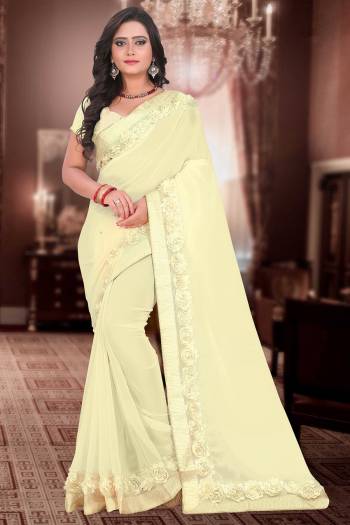 Celebrate This Festive Season And Party Wear In This Very Pretty Cream Colored Designer Saree Paired With Blouse. This Saree Are Georgette and Blouse Are Banglori Silk Based Beautified With Detailed Floral,Ribbon Work. 