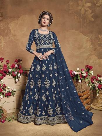 Get Ready For The Upcoming Wedding Season With This Attractive Looking Heavy Designer Floor Length Suit In Aqua Blue Color. This Pretty Heavy Embroidered Suit Is Fabricated On Butterfly Net Paired With Satin Bottom And Butterfly Net Fabricated Dupatta. Its Bright Color And Heavy Embroidery Will Give An Attractive Look To Your Personality.